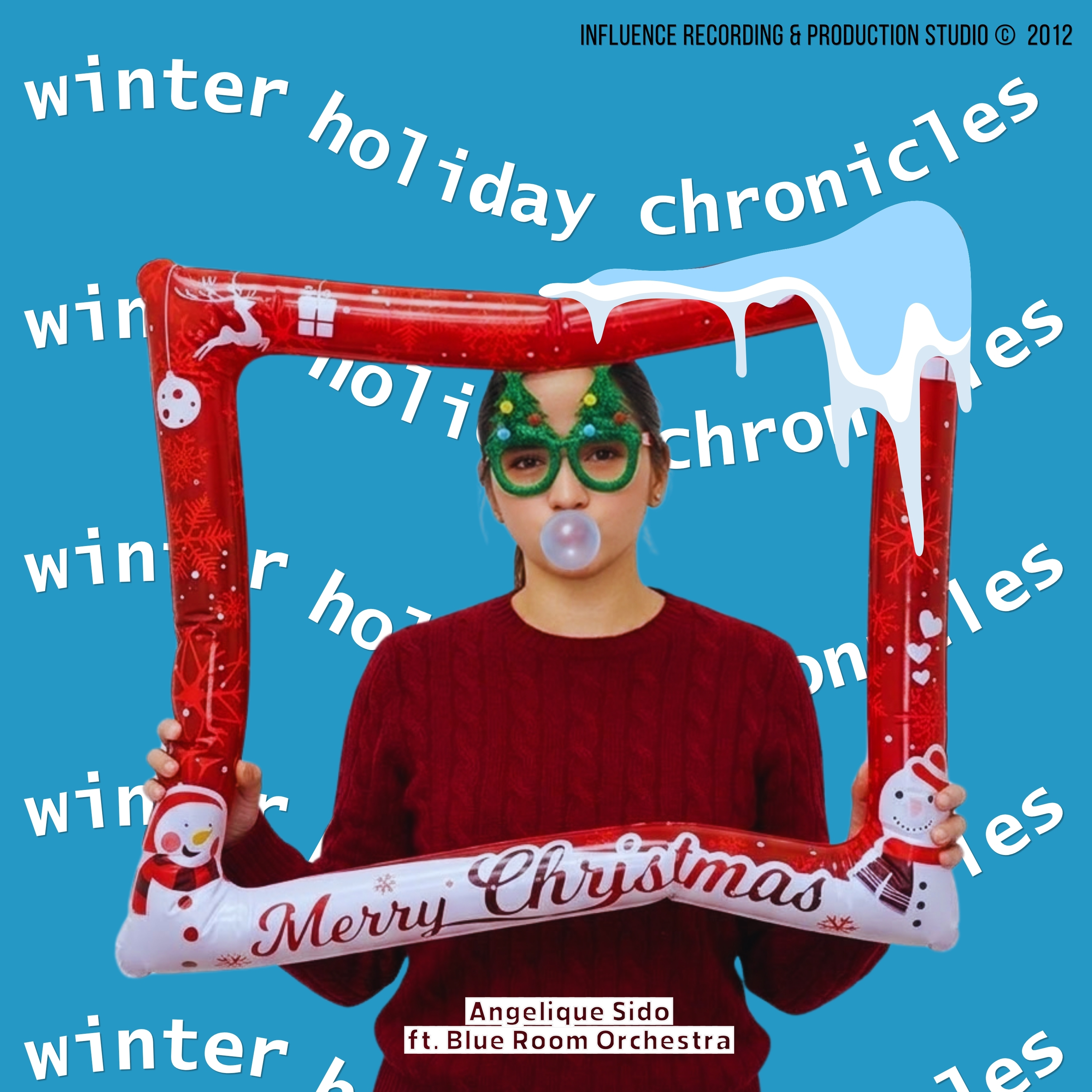 A person wearing festive accessories, including Christmas-themed glasses and a red sweater, poses with a large, inflatable frame that says 'Merry Christmas.' They are blowing a bubble with gum.